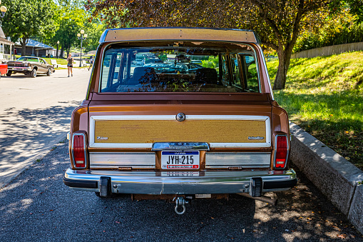 Des Moines, IA - July 03, 2022: High perspective rear view of a 1986 Jeep Grand Wagoneer at a local car show.