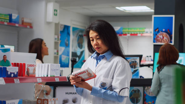istock Asian specialist analyzing boxes of supplements on shelves 1442487619