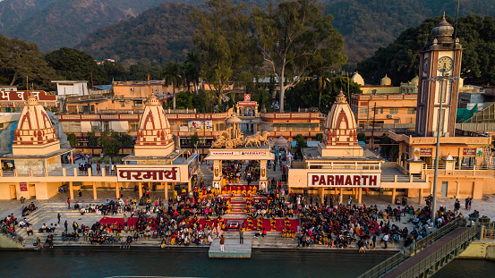 holy ganges riverbank filled with religious temples at evening aerial shot image is taken at parmarth ashram rishikesh uttrakhand india on Mar 15 2022.