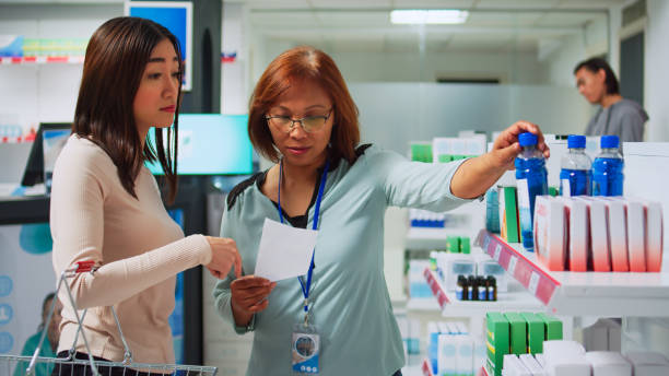 istock Young pharmacist reading prescription paper in pharmacy 1442489302