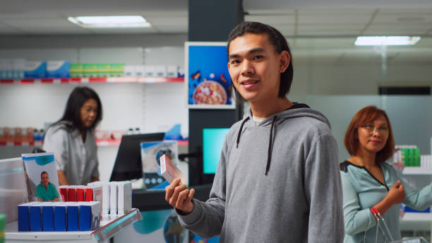 istock Asian man reading leaflet on pills box in pharmacy 1442489828