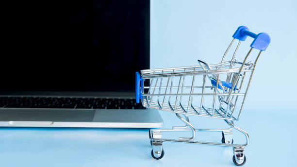 istock A small cart for a supermarket on a computer background 1442492144