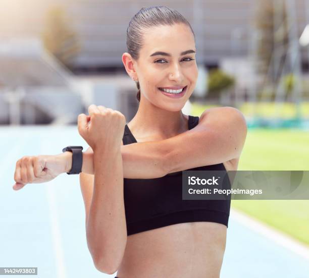 Fitness Woman Portrait Stretching Arms And Training On Sports Track For Marathon Exercise And Workout In Stadium Arena Outdoor Happy Smile And Strong Athlete Prepare Body To Start Cardio Running Stock Photo - Download Image Now