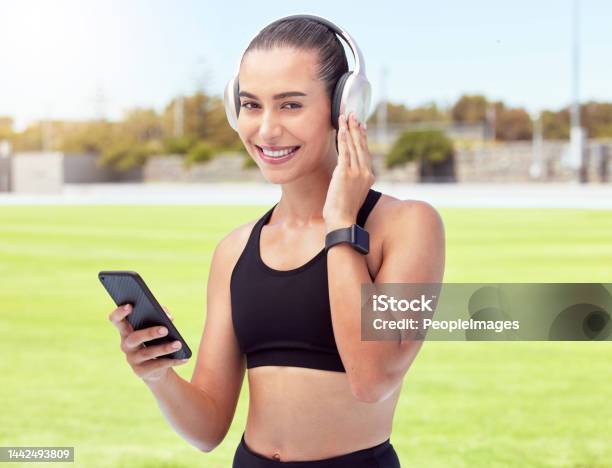Woman Fitness Runner Listening To Music 5g Phone For Motivation Wellness Or Training Outdoor Sport Or Event Girl Sports Athlete Workout Running And Podcast Or Radio Exercise For Cardio At Stadium Stock Photo - Download Image Now