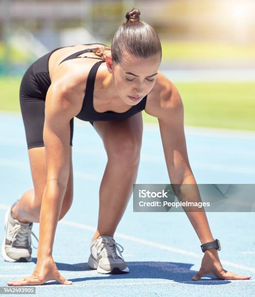 Runner Woman And Focus Of A Athlete About To Start A Run On A Sport Track Outdoor Fitness Sports And Motivation For Workout Training For Running In A Exercise For Healthy Living And Strong Cardio Stock Photo - Download Image Now