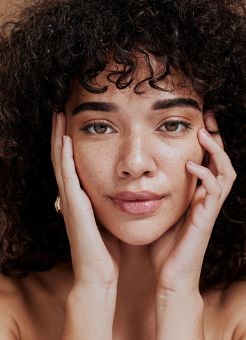 Beauty, portrait and natural face of black woman with healthy freckle skin texture touch. Aesthetic, facial and skincare cosmetic model girl touching cheeks for self love and wellness.