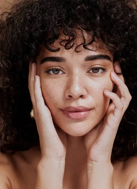 Photo of Beauty, portrait and natural face of black woman with healthy freckle skin texture touch. Aesthetic, facial and skincare cosmetic model girl touching cheeks for self love and wellness.
