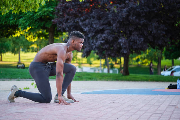 istock Young fit shirtless black man ready to run outdoors on sunny summer day. 1442497123