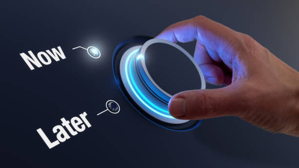 istock Now versus Later words, stop procrastinating concept. Time management, personal development, business strategy, decision making. Take action, avoid postponing. Hand turning knob. 1442497427