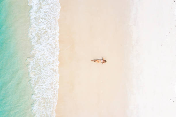 istock Woman in swimsuit sunbathing on tropical island 1442498103