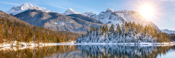istock landscape in winter with mountain range and sun on blue sky 1442498406