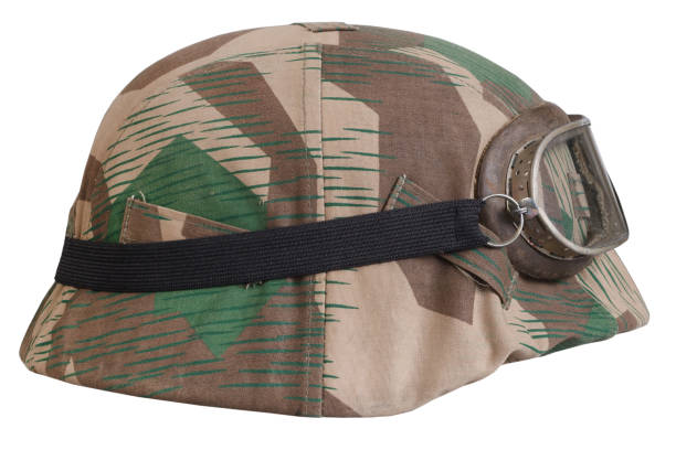 istock German army helmet with with protective goggles and camouflage cover, type Splinter, helmet M35, M40, M42. 1442499646