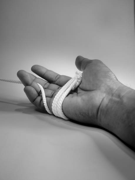 istock Mens holding a rope and tied on hand 1442500402