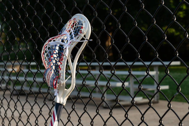 Mens Lacrosse Stick Leaning on a Fence