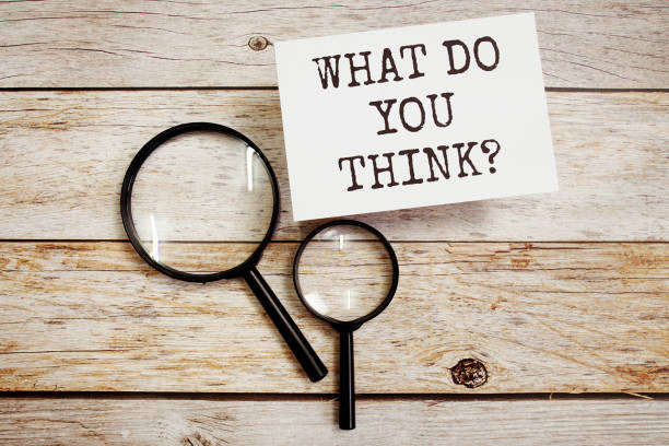 istock What do you think? text message with magnifying glass on wooden background 1442502653