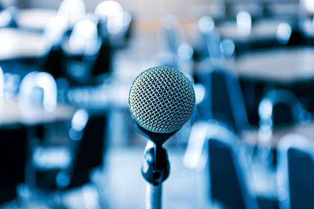 istock Close up microphone with tripod on stage in seminar room. 1442507842