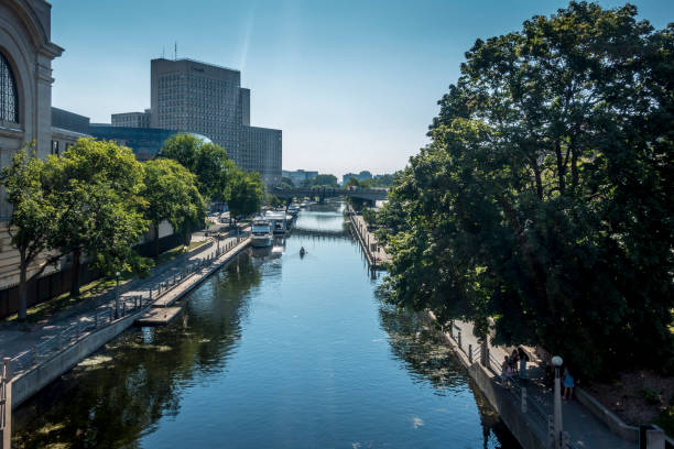 Ottawa, Canada - August 20, 2022: View along Rideau Canal with a length of 202km is a UNESCO world heritage site. Chateau Laurier Hotel on right side. Ottawa is the capital city of Canada.