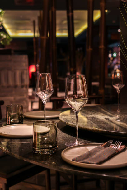 istock Asian Restaurant table with place setting and wine glasses in dark evening atmosphere 1442510356