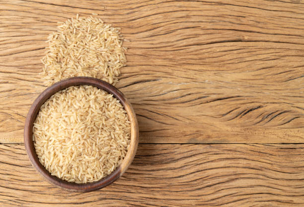istock Raw brown rice in a bowl over wooden table with copy space 1442510366