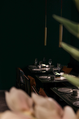 Asian Restaurant table with place setting and wine glasses in dark evening atmosphere