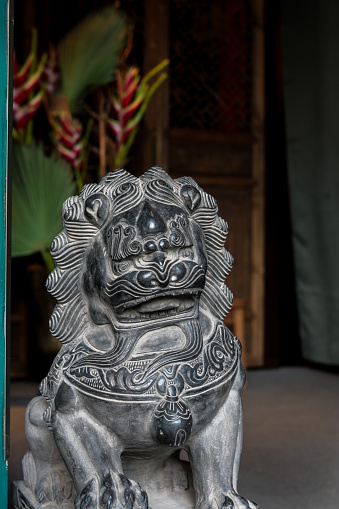Chinese guardian lion statue sculpture foo dog at house entrance acting as guardian