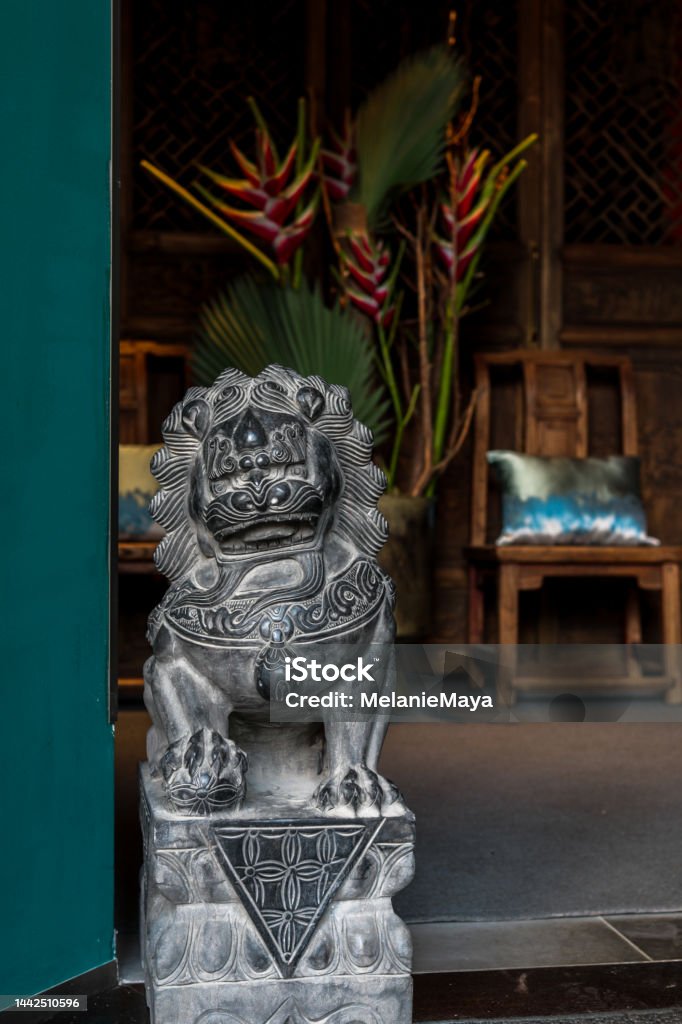 Chinese guardian lion statue sculpture foo dog at house entrance Chinese guardian lion statue sculpture foo dog at house entrance acting as guardian Ancient Stock Photo