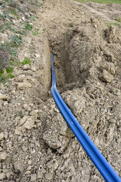 istock High voltage electrical cables is laid in a trench. Plastic cables in the soil 1442511752