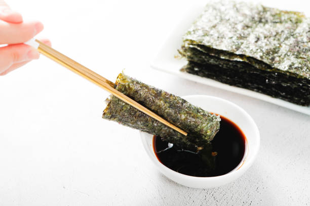 nori(laver), a kind of seaweed, and dipped it in soy sauce a type of seaweed, is dried and eaten as it is, or seasoned with grilled seaweed and corn oil ascidiacea stock pictures, royalty-free photos & images