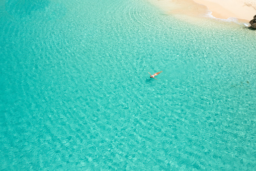 Aerial of woman floating at Meads Bay Beach, Anguilla