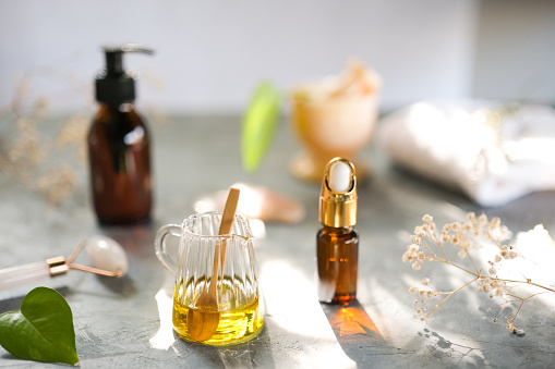 Natural skin care oil, glass dropper bottle and organic leaf homemade hair care oil and beauty products