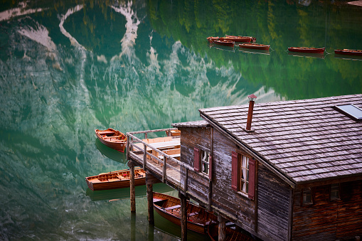 Lago di Braies or Pragser wildsee, Italy. Spectacular romantic place with typical wooden boats on the alpine Lake Braies, Dolomites, South Tyrol.