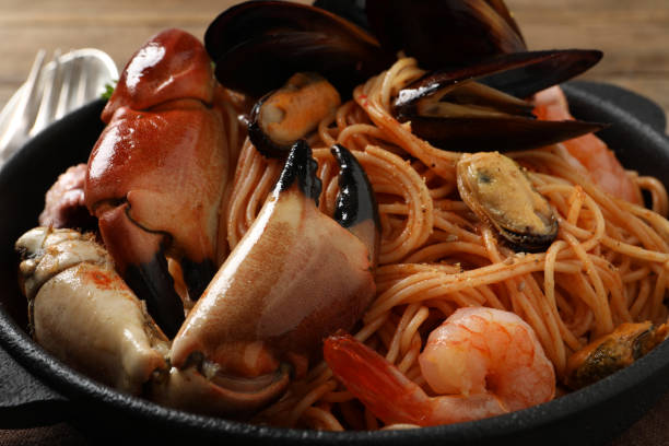 istock Delicious spaghetti with seafood on table, closeup 1442515817