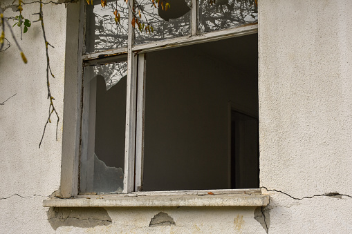 shattered and cracked glass after hitting a metal framed window - lines of bandalism