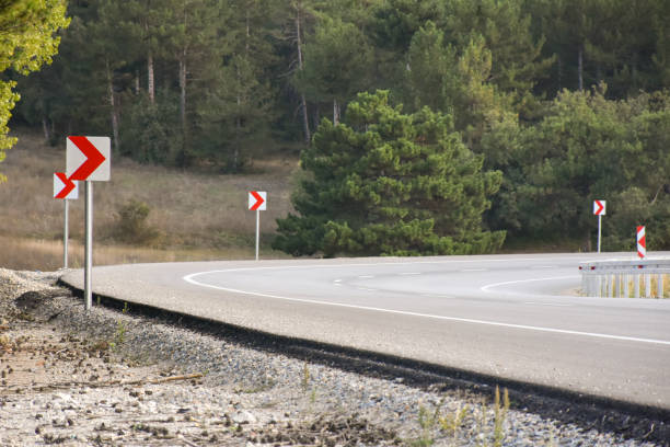 istock Winding road. Empty winding asphalt road with road signs 1442517855