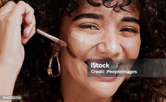istock Face, makeup and brush with a woman black model applying foundation to her skin in studio for cosmetics. Portrait, wellness and luxury with an attractive young female using a cosmetic product 1442518256
