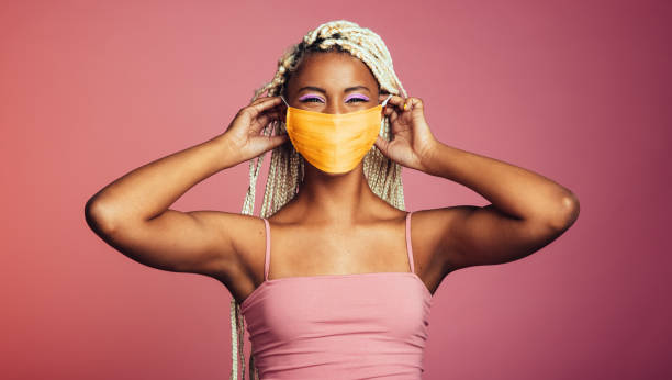 istock Smiling african woman wearing protective face mask 1442521586