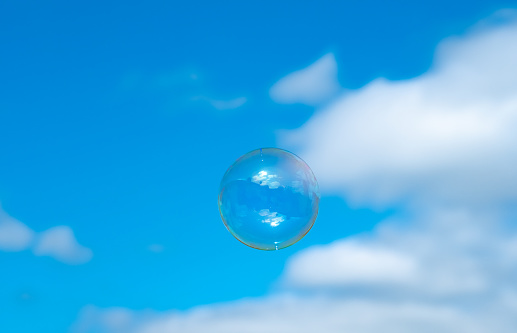 an airy background image with a soap bubble with blue sky