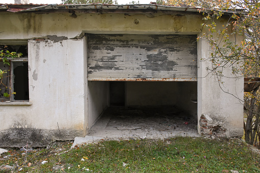 Interior of abandoned house falling apart with debris covering floor