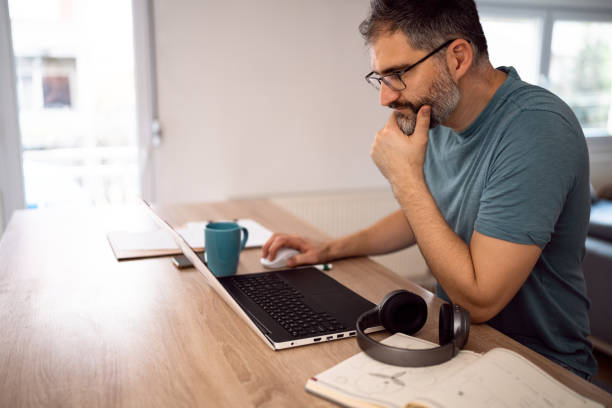 istock Man working on laptop from his home 1442525940