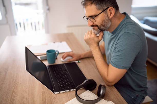 istock Man working on laptop from his home 1442525959