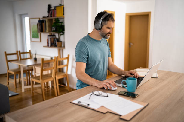 istock Modern Caucasian man working from home on laptop 1442526237
