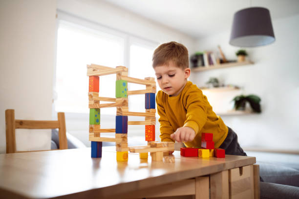 istock Boy playing with wooden blocks at home 1442527371