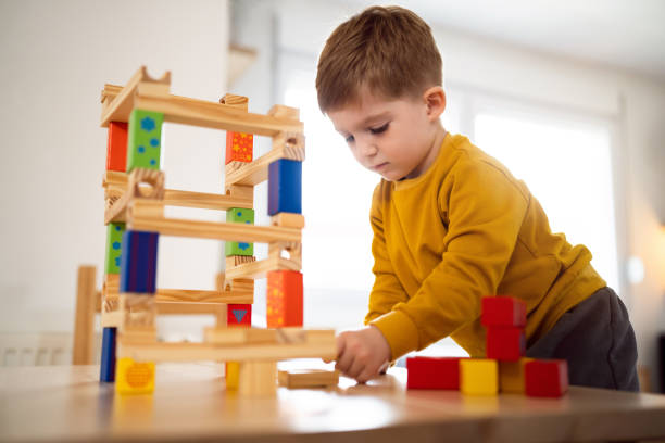 istock Boy playing with wooden blocks at home 1442527616