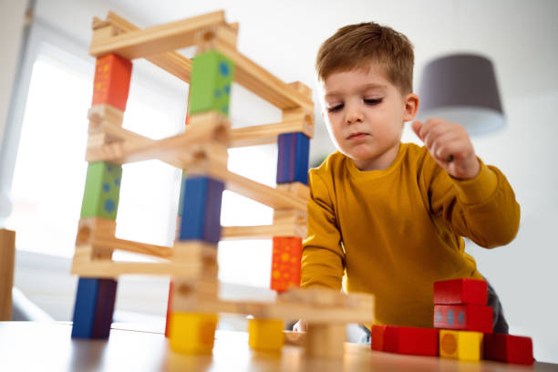 istock Boy playing with wooden blocks at home 1442527654