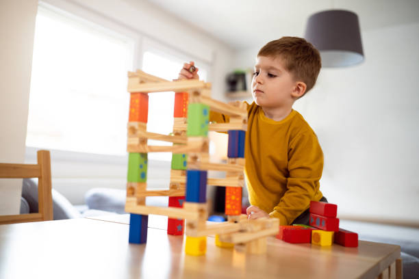 istock Boy playing with wooden blocks at home 1442527718