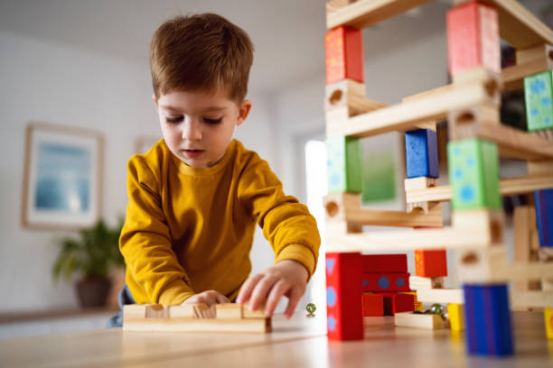 istock Boy playing with wooden blocks at home 1442527805