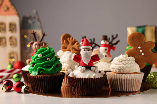 istock Different beautiful Christmas cupcakes and baubles on white table 1442528036