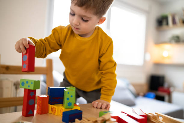 istock Boy playing with wooden blocks at home 1442528135