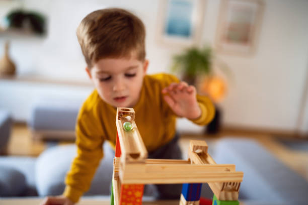 istock Boy playing with wooden blocks at home 1442528377