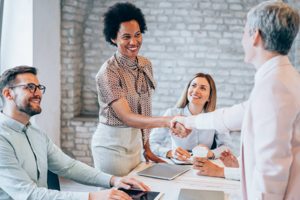 istock Business persons shaking hands across the table. 1442530030